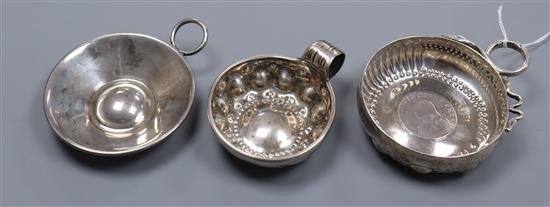 Three assorted 19th century and later French white metal taste vin, including one with inset coin base, largest 12.2cm.